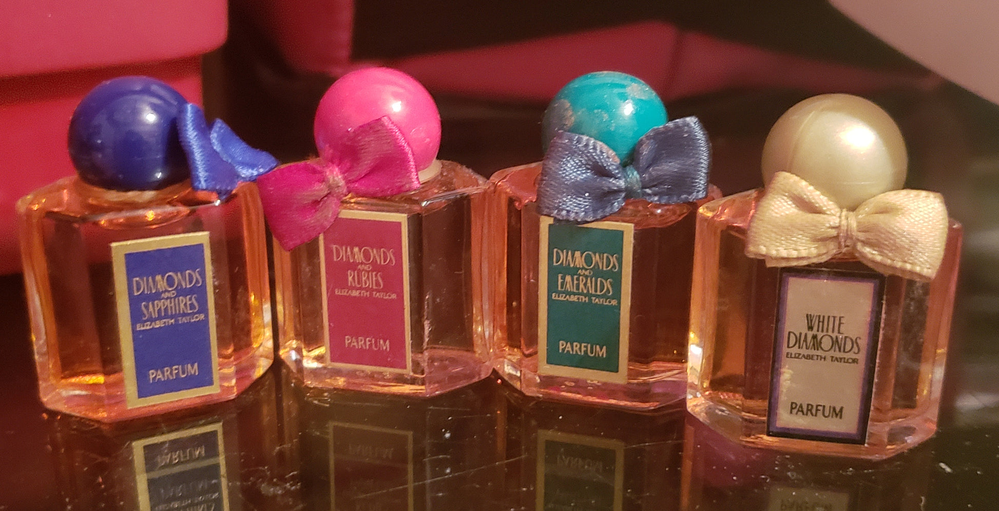 small Perfume bottles with the perfume in all four Diamonds Sapphire, Rubies, Emerads, and White Diamonds
